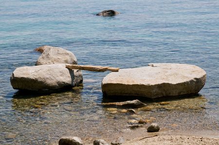 Bridge over rocks at shore of lake Tahoe, Californiaの写真素材