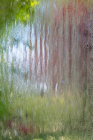 Water running over patterned glass - modern abstract in garden settingの写真素材