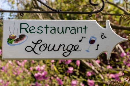 Old wooden painted sign - Restaurant, Lounge against garden backgeoundの写真素材