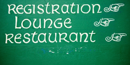 Wooden directional sign on hotel wallの写真素材