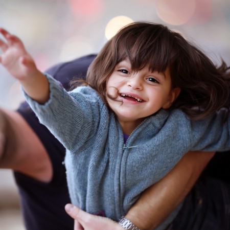 The child with happiness in eyes, feeling kindness of the world up to tips of fingers and its iridescent paints.の写真素材