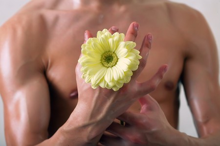 Sunburnt man with a flower in a hand. Look other photos of this series:の写真素材