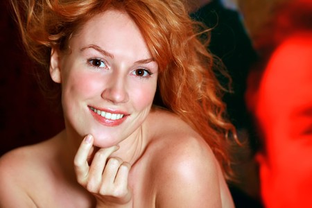 Portrait of the beautiful red-haired girl looking in an objectiveの写真素材