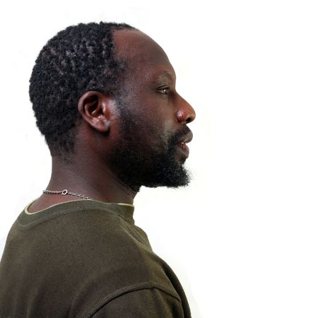 Portrait in a profile of the young black man with a small beard, isolated on a white backgroundの写真素材