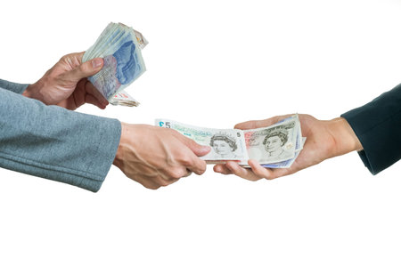 Two businessmen exchanging british money pounds sterling on white background