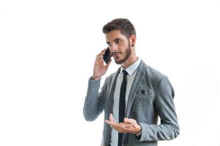 Young successful businessman smiling and talking on the phone isolated on white