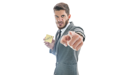 Angry business man. Boss pointing out and firing employeeの写真素材