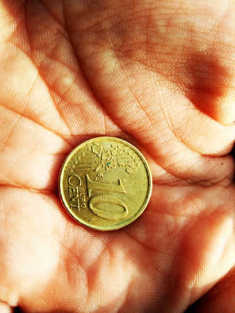 10 cents coin in a handの写真素材