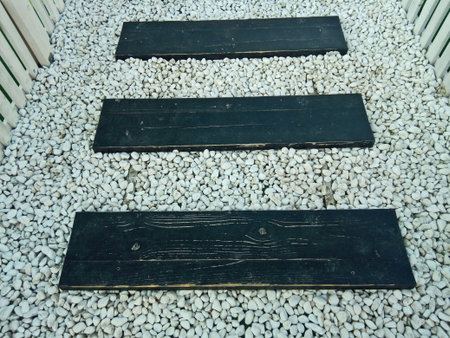 artificial wooden path and white stones - conceptの写真素材