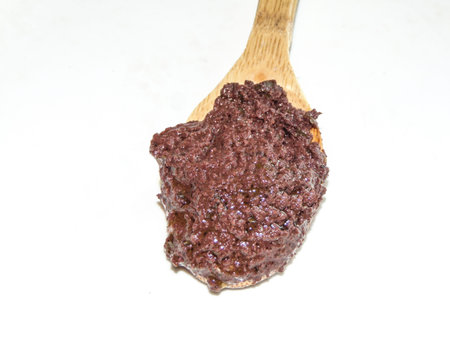 Kalamon olive paste on a wooden spoon