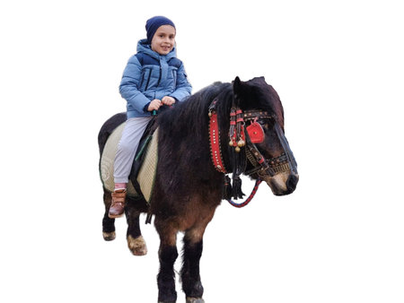A child is riding a pony. Romanian boy on a ponyの写真素材