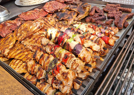 Skewers and other types of meat on the grillの写真素材