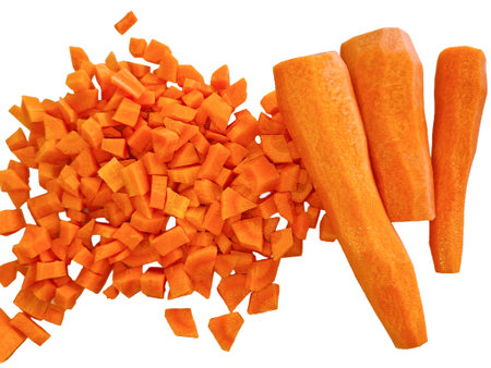 Pieces of chopped carrot and three more pieces of raw carrotの写真素材