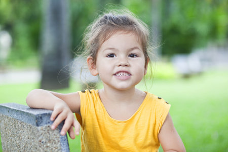 Little Girl in a yellow dress in park