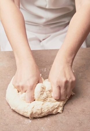 Woman kneading doughの写真素材