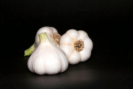 Garlic bulbs, on black background の写真素材