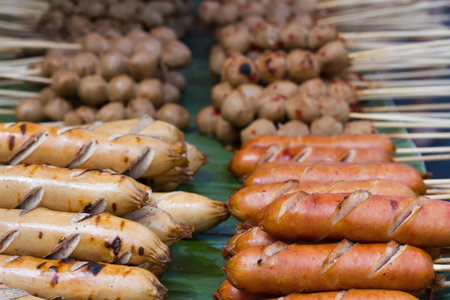 Grilled Thai sausages on the stove  at Traditional Market, Thailandの写真素材