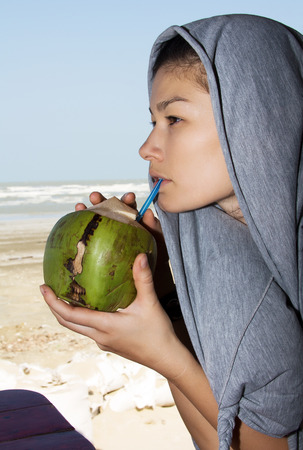 Beautiful woman drinking coconut juiceの写真素材