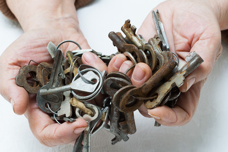Bunch of old keys in hands の写真素材