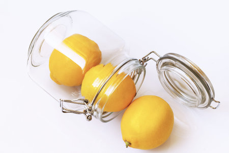 Lemons in jar isolated on white