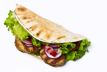 Sandwich with beef cutlet lettuce onions and tomato in bunの写真素材