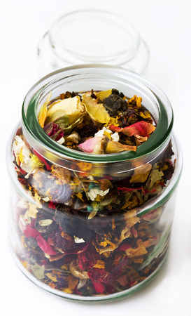 Tea with fruit and dry flower in glass jar on white backgroundの写真素材