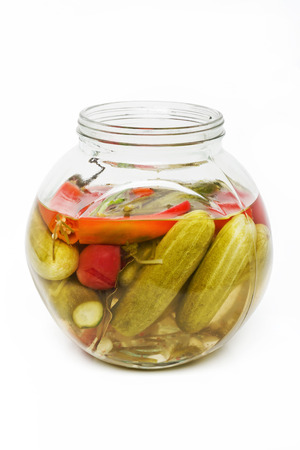 Pickled cucumbers and chili pepper in a glass jar.の写真素材