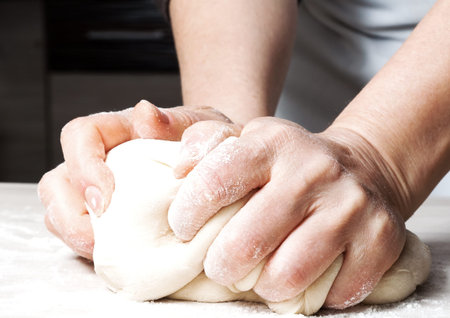 Hands kneading a dough