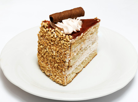 Sponge cake with cream and chocolate on white backgroundの写真素材