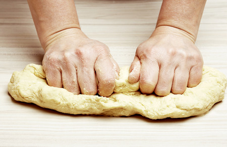 Woman kneads doughの写真素材