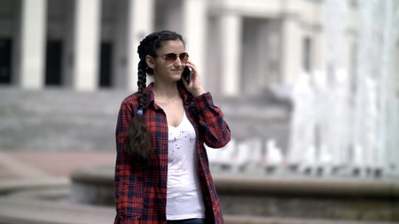 girl talking on the phone in the cityの写真素材