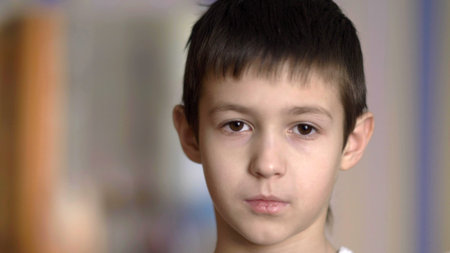 portrait serious boy looking at camera, have fun