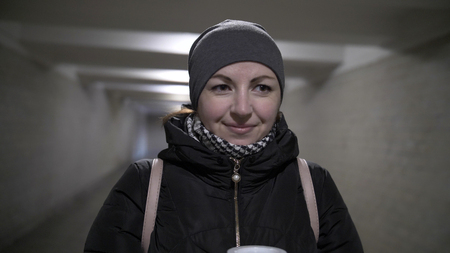 smiling woman in a tunnel in winterの写真素材