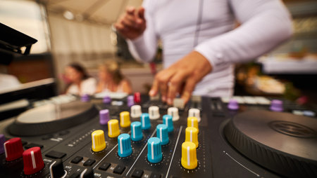 Dj plays beats on drum machine.Hip hop disc jockey playing on concert stage with professional midi controller device. Beat machine device for electronic music composer.の写真素材