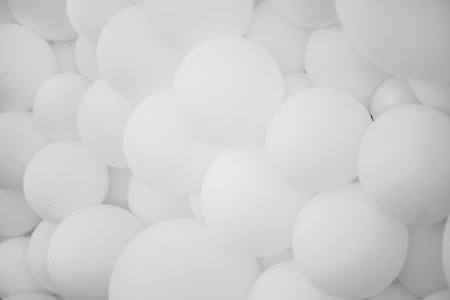 A lot of white balloons, background. Many white balloons, inflatable balls, background of white and gray circles. Holiday concept. Abstract background.Black and white photoの写真素材
