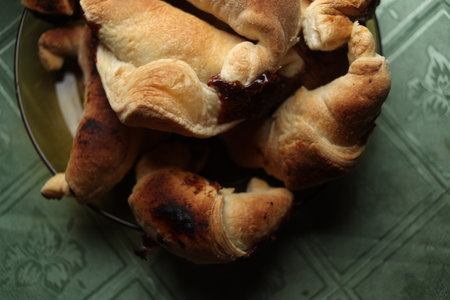 Sweet Chocolate Croissants, selective focus on old vintage background. Fresh homemade croissants with chocolate. Croissant with chocolate topping on the plate.の写真素材
