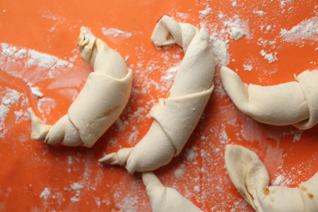 Producing classic croissants. Crescent rolls before baking. croissants on a tray. French Pastry goods, bakery. Dough for croissants. Preparation of croissants.の写真素材