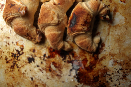 Sweet Chocolate Croissants, selective focus on old vintage background. Fresh homemade croissants with chocolate. Croissant with chocolate topping on the plate.の写真素材