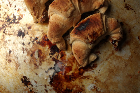 Sweet Chocolate Croissants, selective focus on old vintage background. Fresh homemade croissants with chocolate. Croissant with chocolate topping on the plate.の写真素材