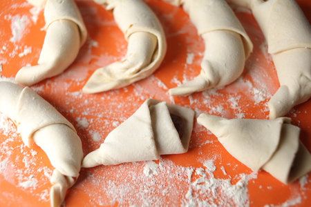 Producing classic croissants. Crescent rolls before baking. croissants on a tray. French Pastry goods, bakery. Dough for croissants. Preparation of croissants.の写真素材