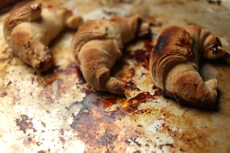 Sweet Chocolate Croissants, selective focus on old vintage background. Fresh homemade croissants with chocolate. Croissant with chocolate topping on the plate.の写真素材