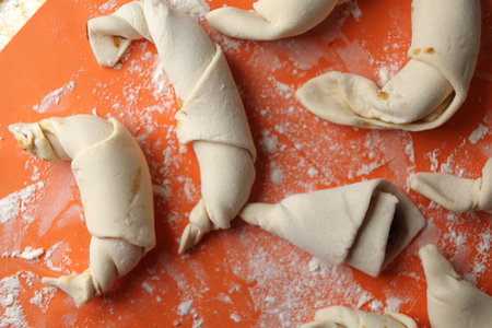 Producing classic croissants. Crescent rolls before baking. croissants on a tray. French Pastry goods, bakery. Dough for croissants. Preparation of croissants.の写真素材