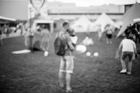 People, Family in a recreation park. Abstract blur people picnic in public park with family or friends, urban leisure lifestyle. Defocused background. Relaxation and recreation concept. Black and white processingの写真素材