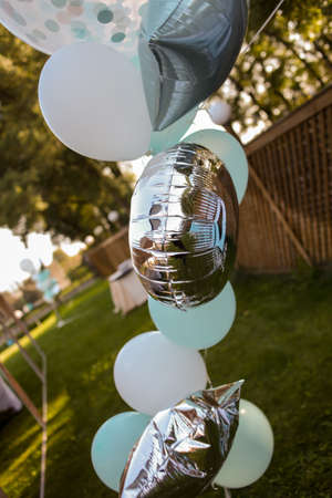 Bouquet of colorful balloons. colorful balloons filled with helium, in the summer, autumn, spring park. colorful balloons, blue, white, silver isolated. Balloons of many colors in a large heapの写真素材