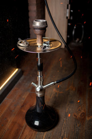 Hookah, coals, hot, shisha, sparks. Sparks from the burning coals hookah. Hookah tobacco in bowl. Shisha hookah with red hot coals. Sparks from breathe.の写真素材