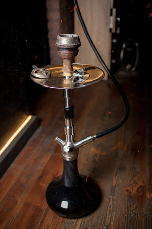 Hookah, coals, hot, shisha, sparks. Sparks from the burning coals hookah. Hookah tobacco in bowl. Shisha hookah with red hot coals. Sparks from breathe.の写真素材