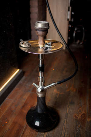 Hookah, coals, hot, shisha, sparks. Sparks from the burning coals hookah. Hookah tobacco in bowl. Shisha hookah with red hot coals. Sparks from breathe.の写真素材