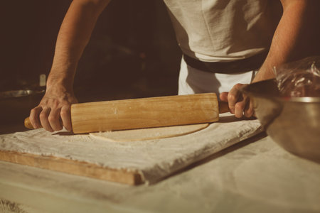 Ingredients for baking strudel stuffed with canned cherries. The cook is preparing a cherry strudel. Country style. See Step of the recipe sequence in step. Hands of a man. The chef puts cherries.の写真素材