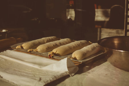 Ingredients for baking strudel stuffed with canned cherries. The cook is preparing a cherry strudel. Country style. See Step of the recipe sequence in step. Hands of a man. The chef puts cherries.の写真素材