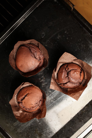 Cake chocolate fondant cake in home oven on the dark black background. Good for menu receipt book...